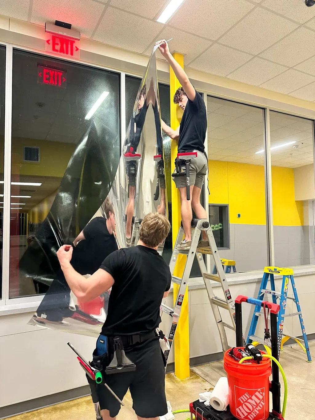 Security window film installation on a Texas school entry vestibule